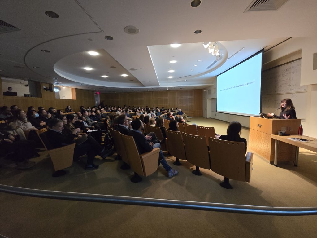 Li-Huei Tsai stands at a podium in front of a large audience in MIT's Singleton Auditorium
